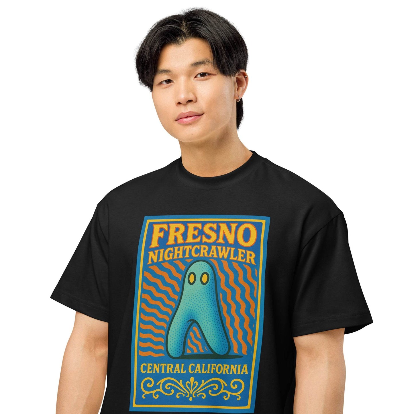 Man wearing black Nightcrawler Fresno tour shirt with blue and orange cryptid design